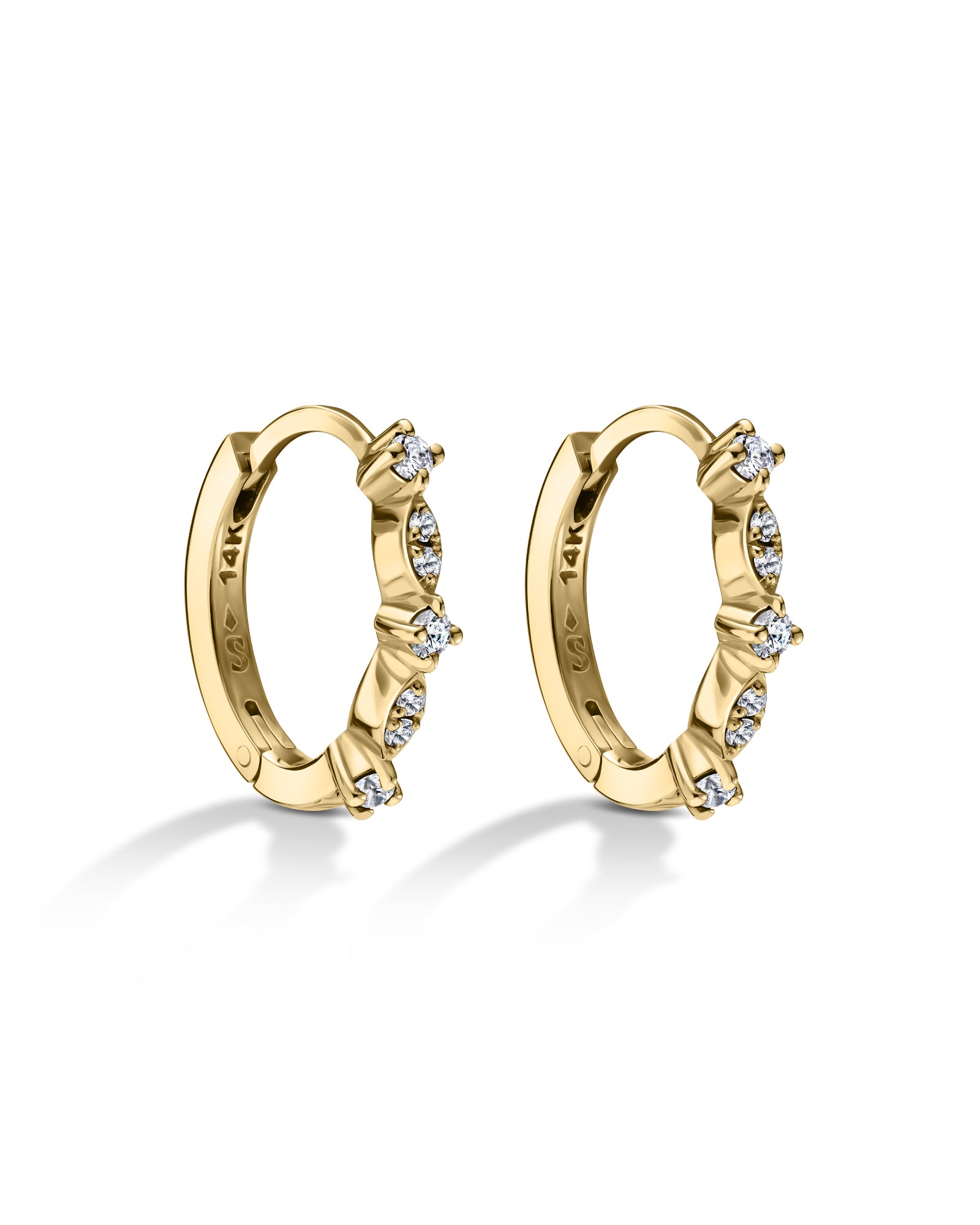 A pair of gold hoop earrings with white diamond accents
