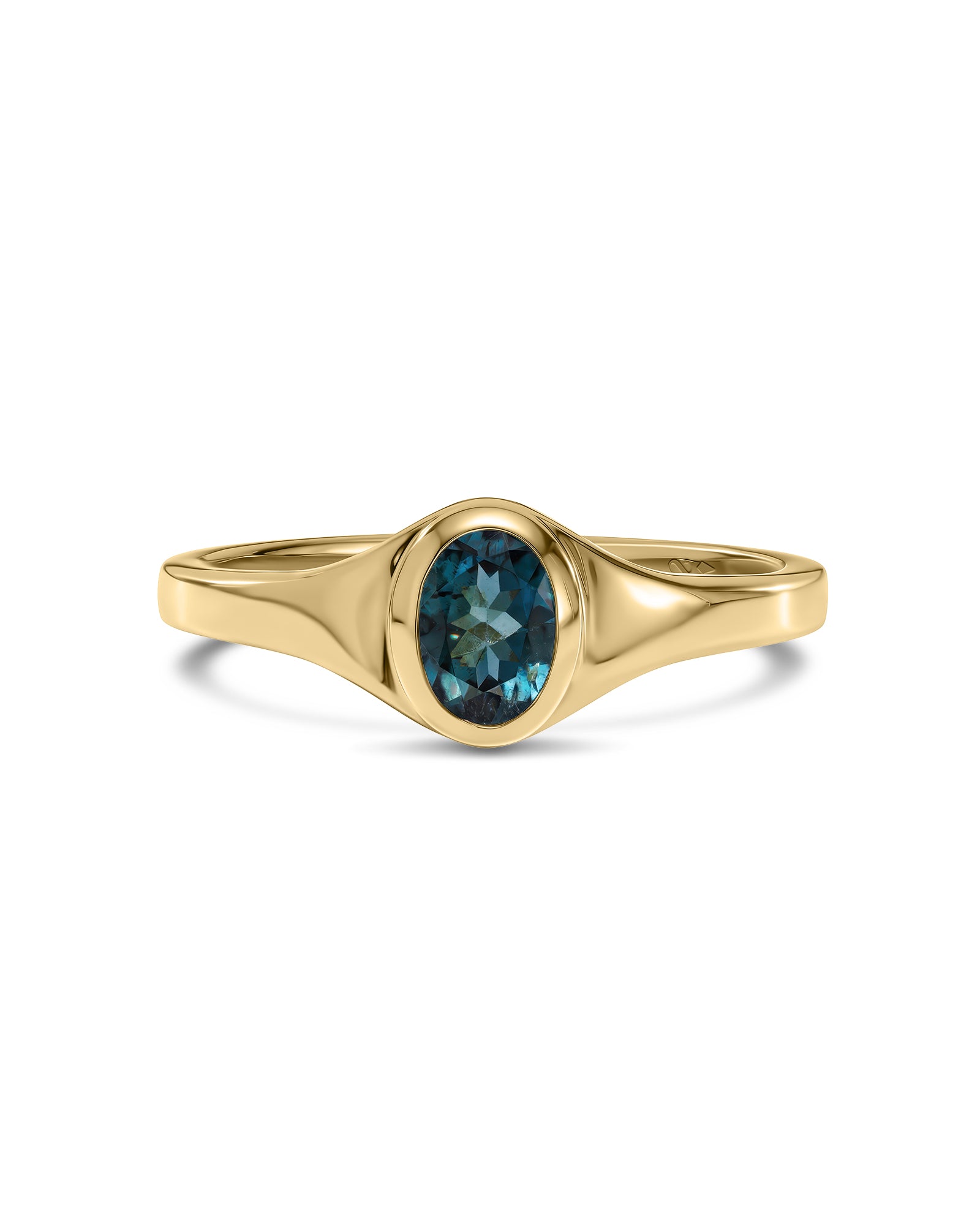 A yellow gold ring featuring an oval-cut deep blue gemstone in a bezel setting, shown against a plain white background.