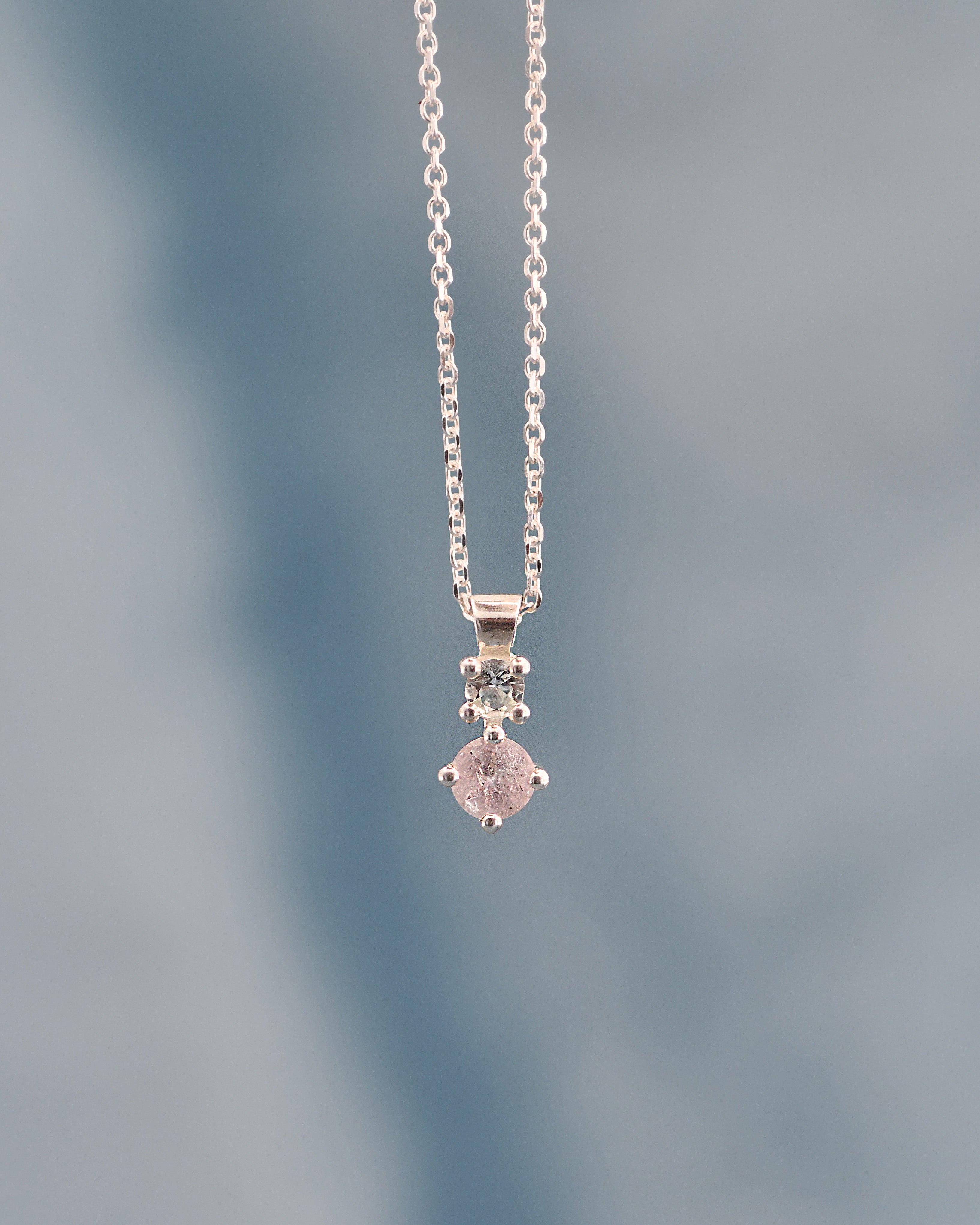 Silver necklace with a pendant on a blurred background