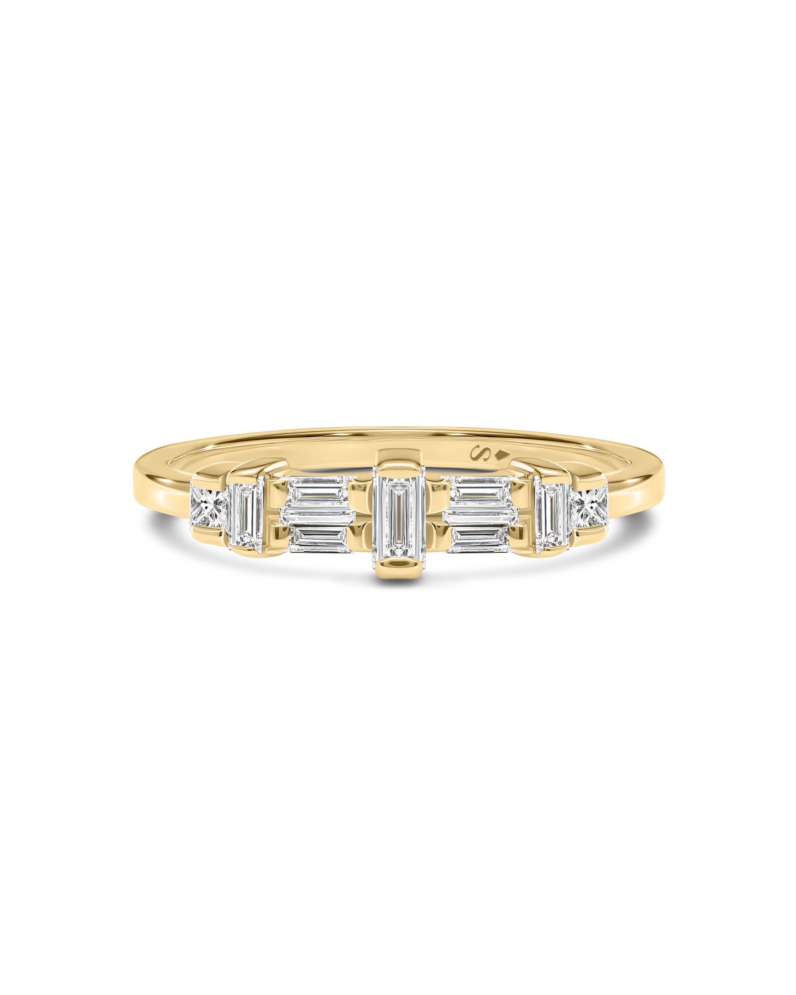 A yellow gold ring featuring a row of baguette and round-cut clear diamonds, photographed on a clean white background.