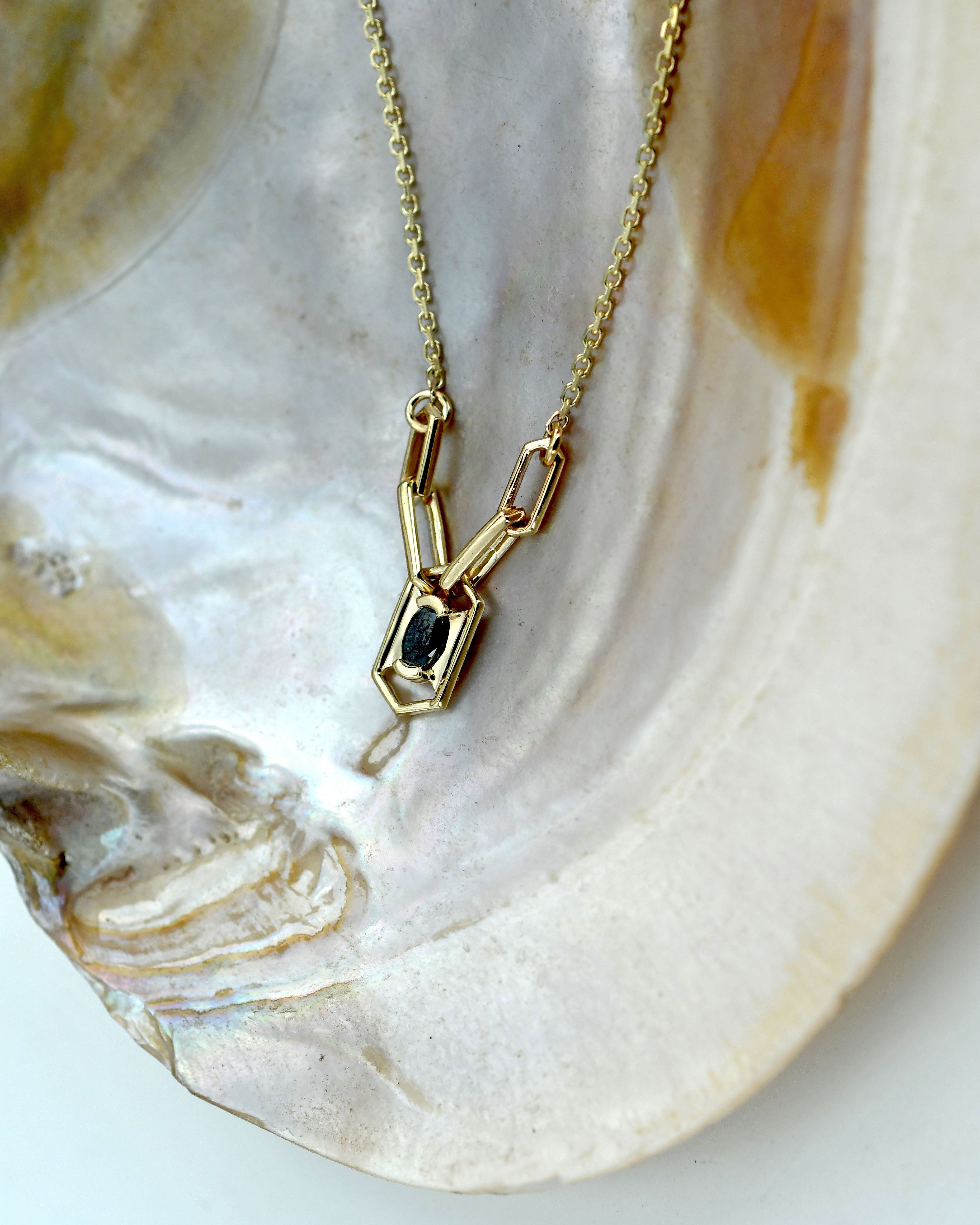 Gold necklace with a pendant and black diamond