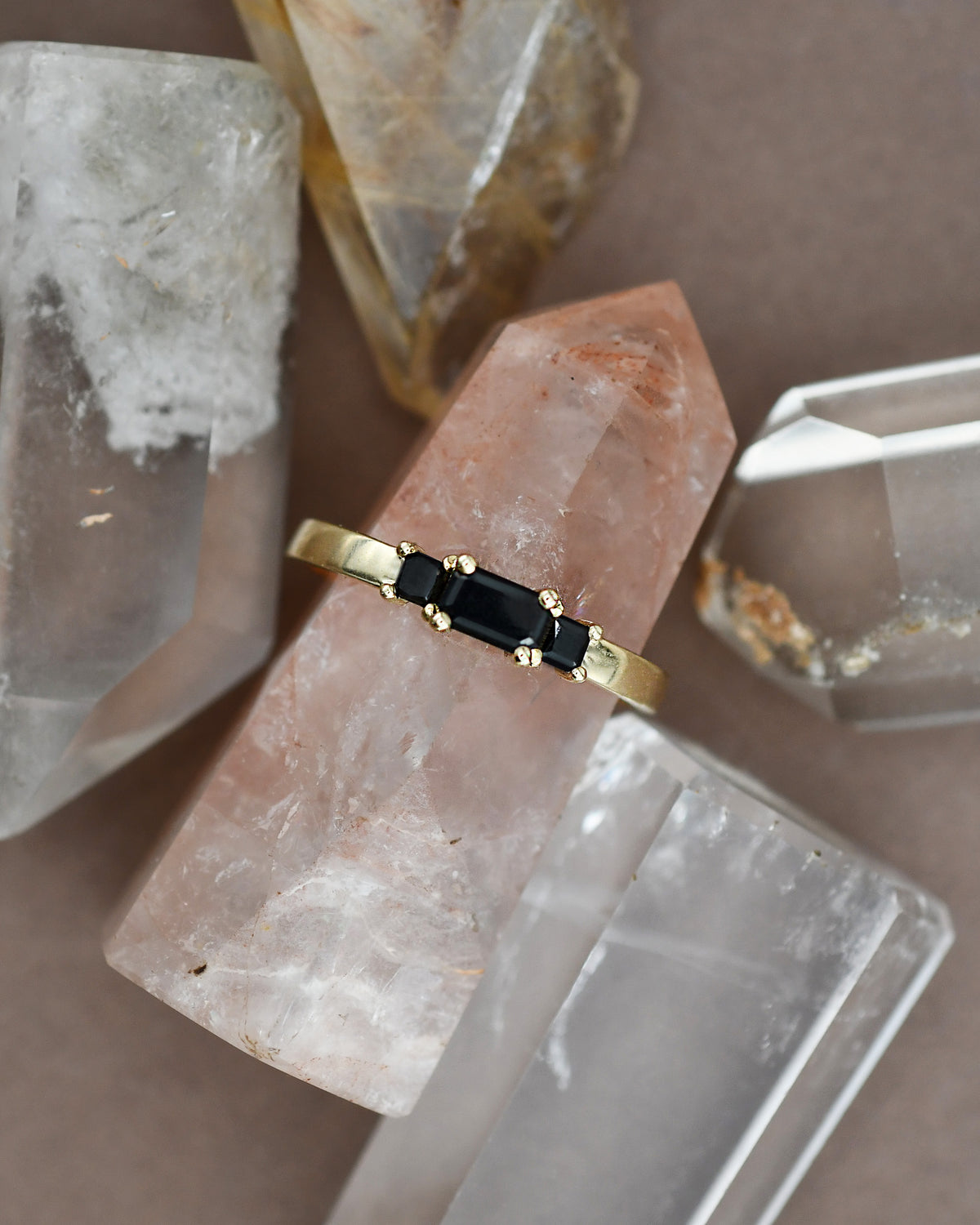 Gold ring with black diamonds on a crystal surface