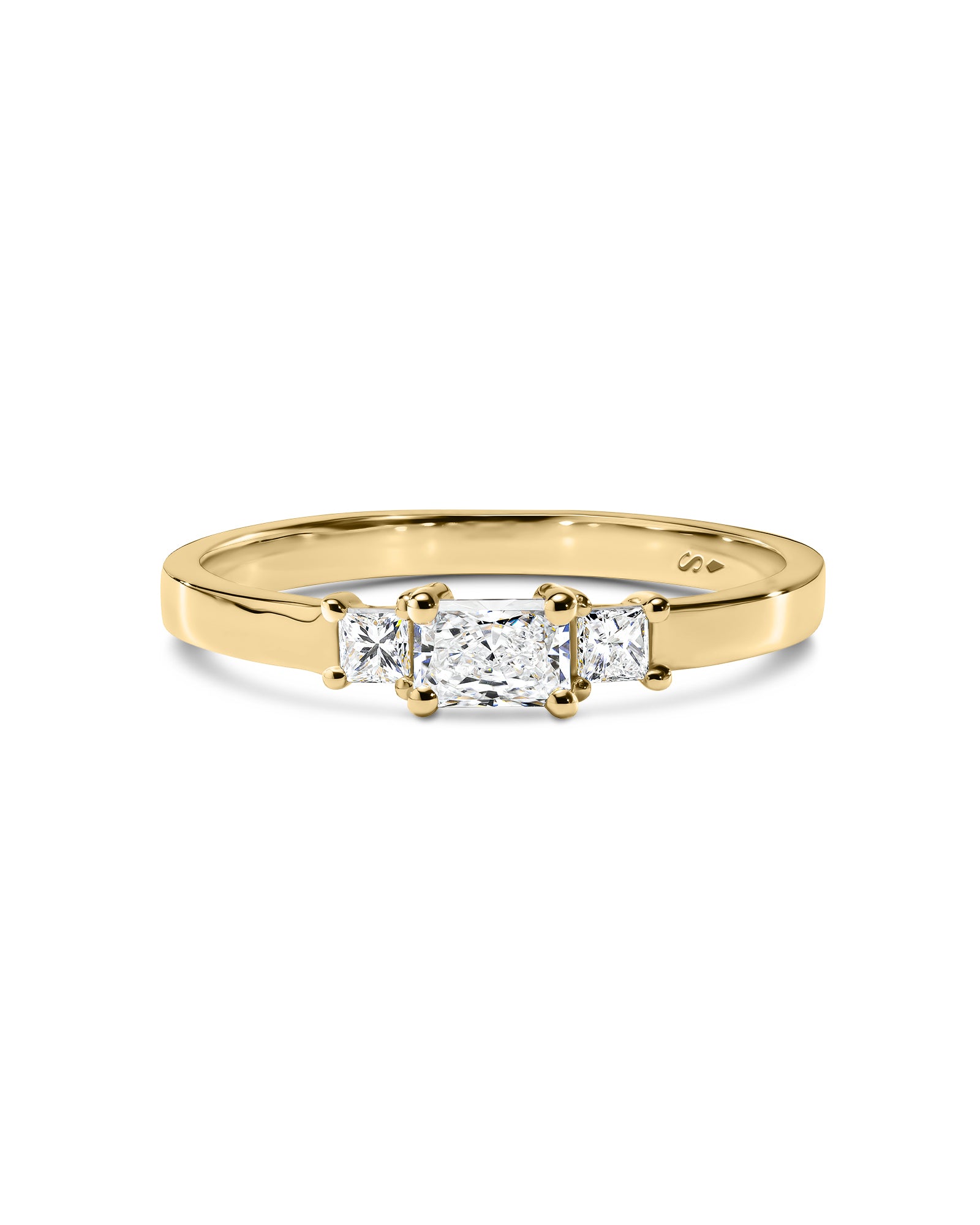 Gold ring with three diamonds on a white background