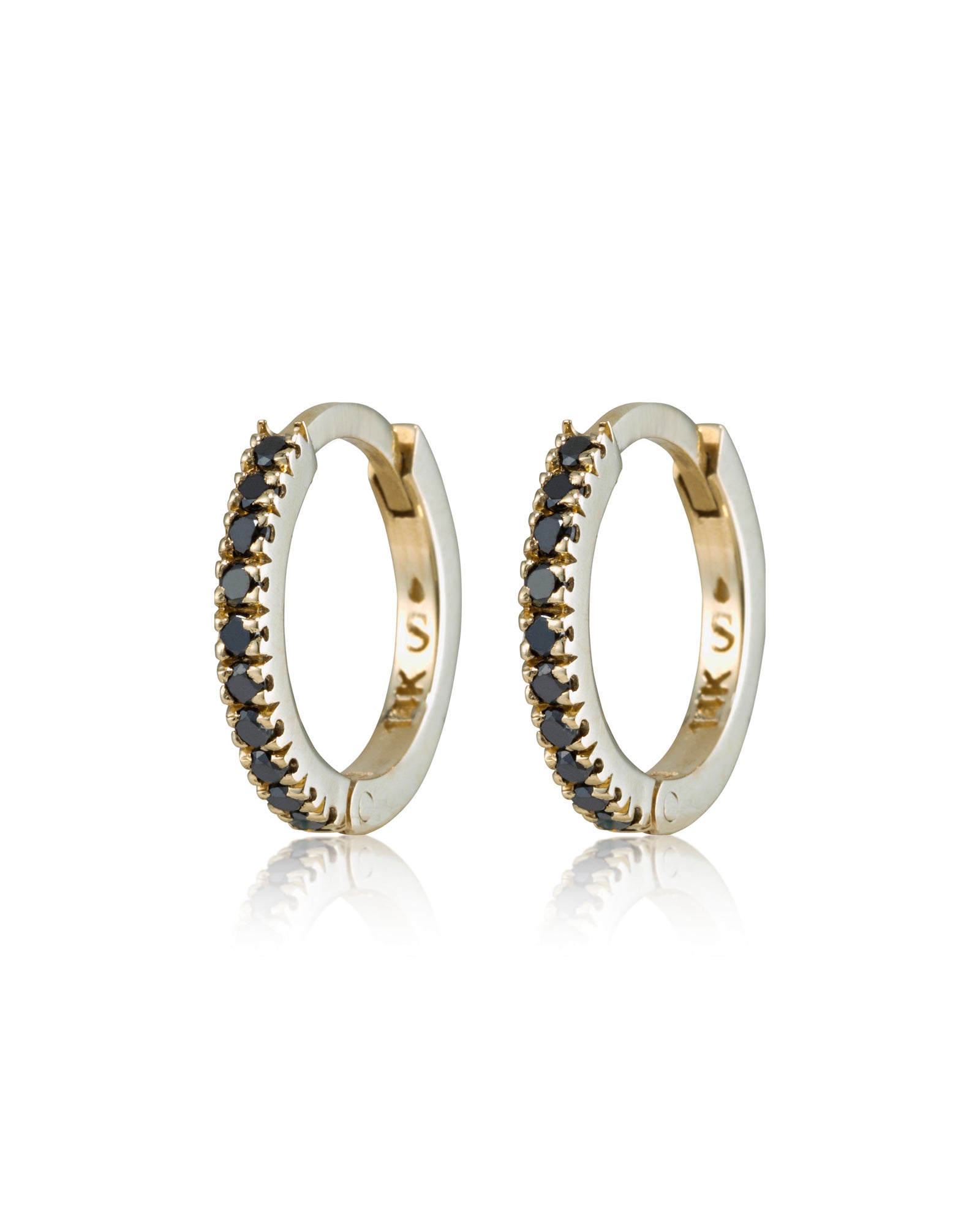 A pair of hoop earrings with black diamonds embedded around the edge, set in a gold-colored metal.