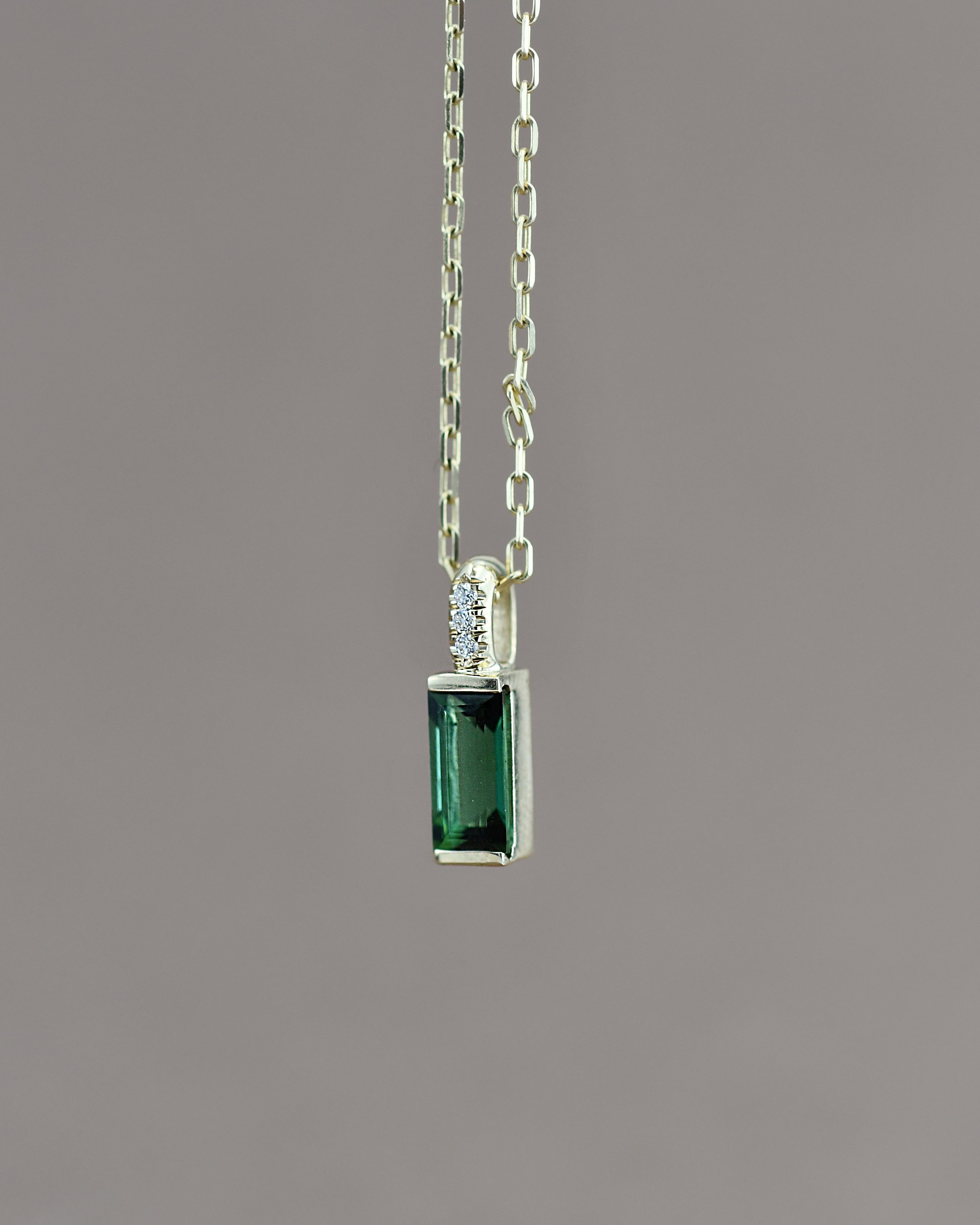 Green gemstone pendant on a chain 