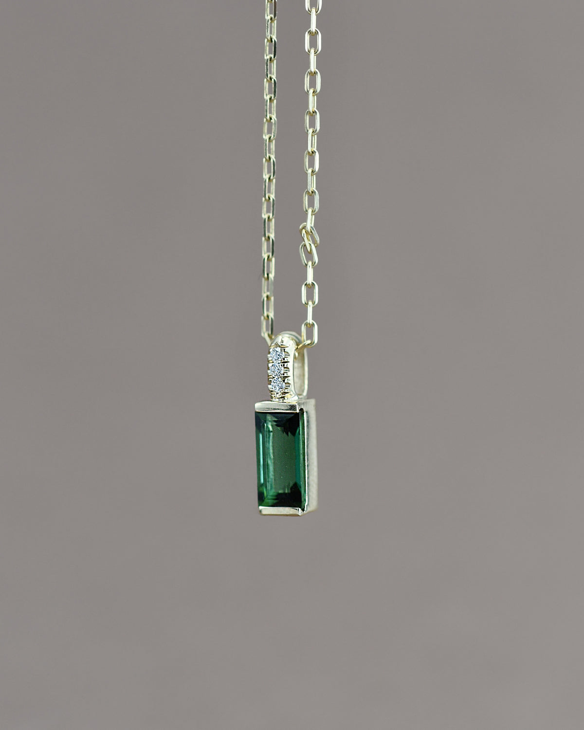 Green gemstone pendant on a chain 