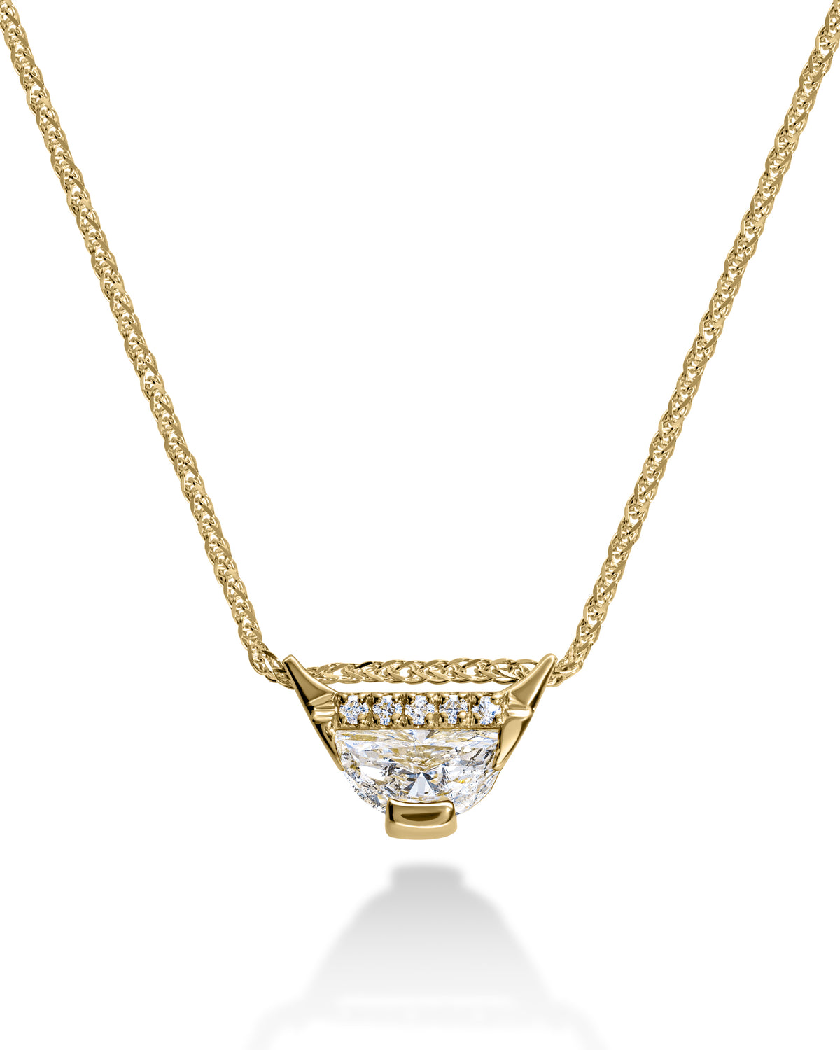 Gold necklace with a diamond pendant on a white background