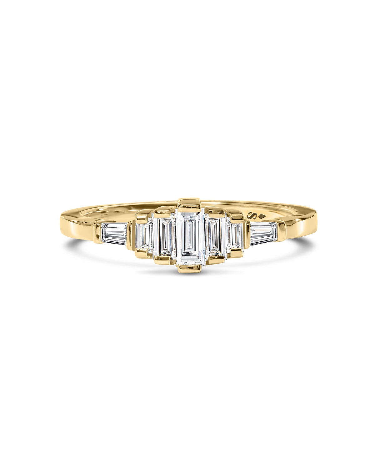 A yellow gold ring featuring a central baguette-cut and kite cut clear white diamonds 