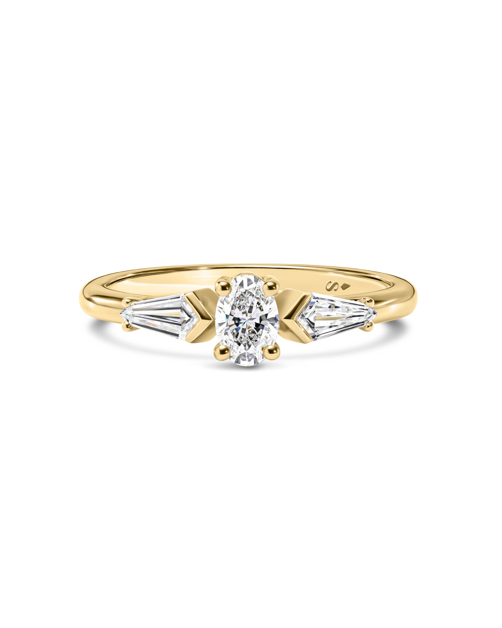 Gold ring with white kite cut and oval cut diamonds on a white background