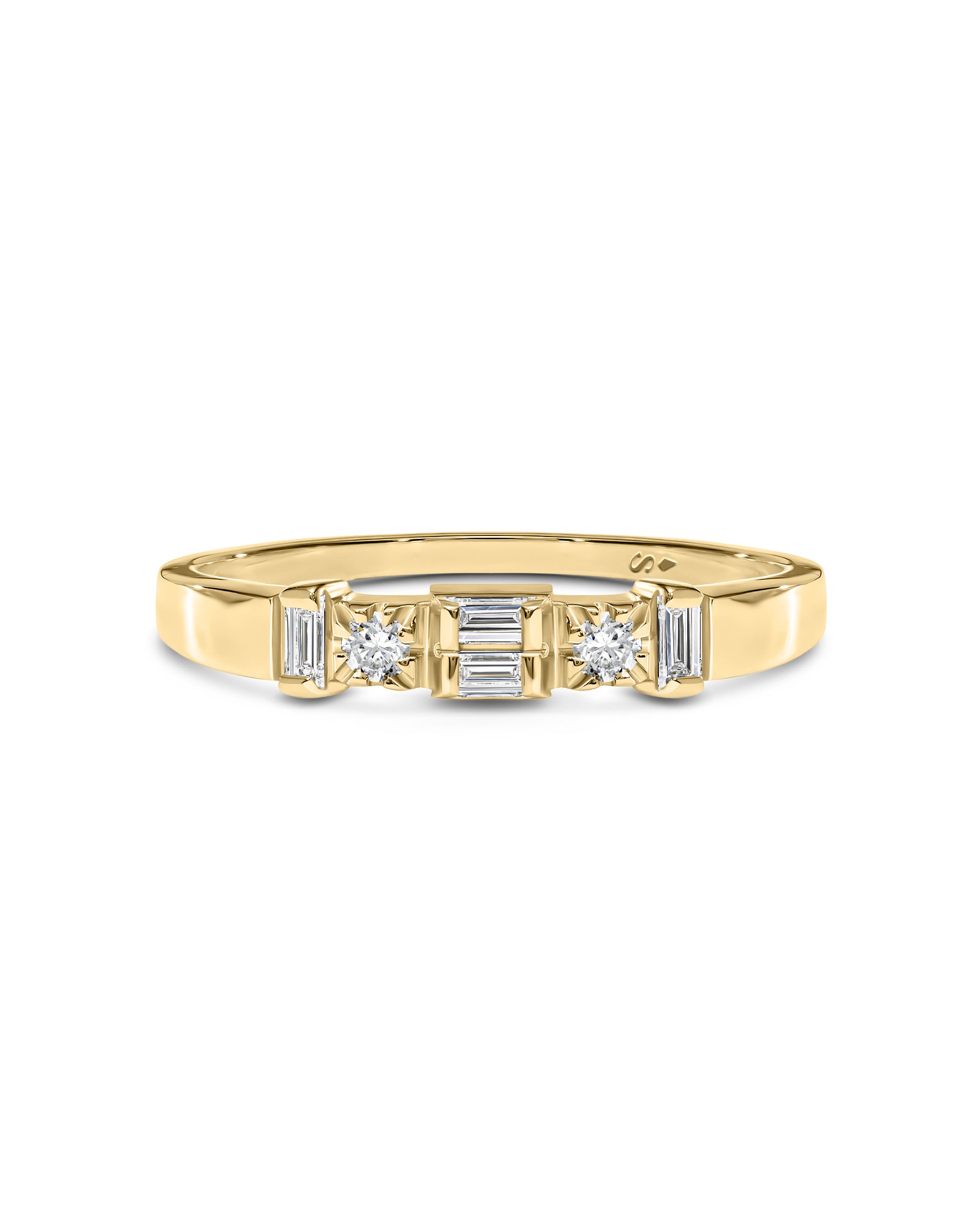 A yellow gold ring with baguette-cut diamond flanked by round and rectangular diamonds, set against a plain white background.