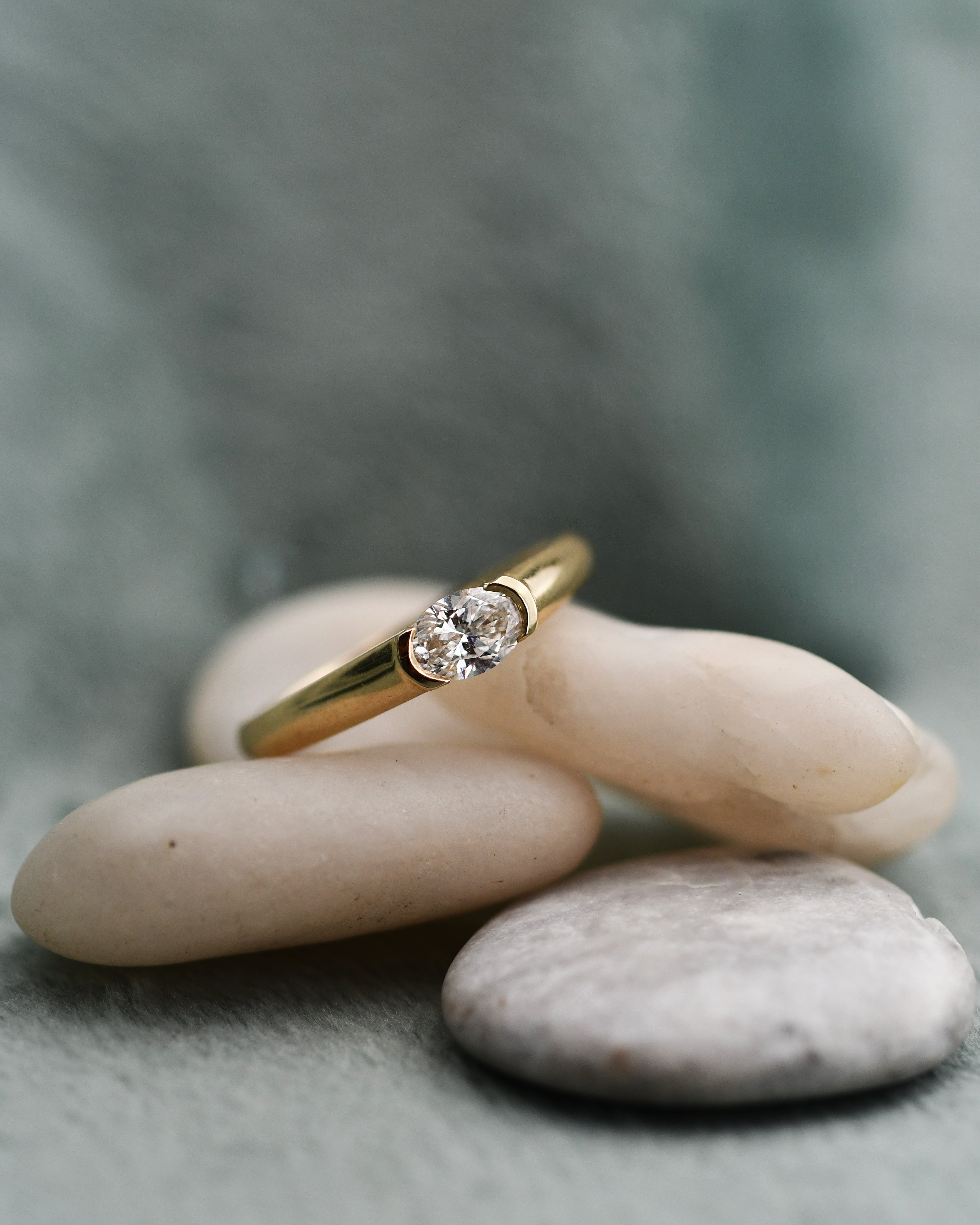 A yellow gold diamond engagement ring with a round-cut clear diamond